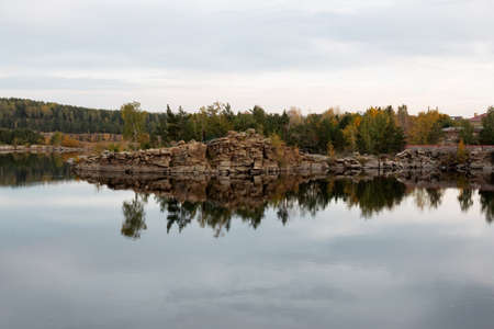 stone autumn lake with birch and pineの写真素材