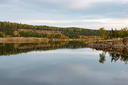 stone cliff surrounds the lake shore Fall
