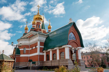 red brick building with orthodox church domes and crossesの写真素材