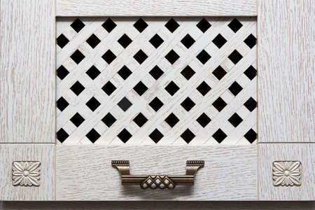 door cabinet with light wooden bars and metal handle in ancient styleの写真素材