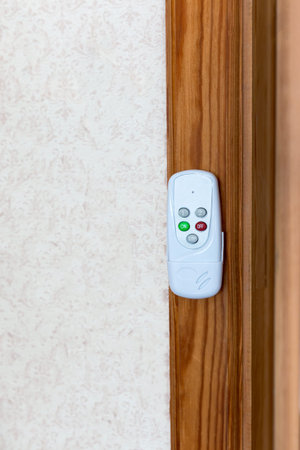 Remote control hangs on the wall of the room