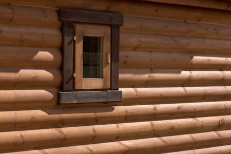 Wooden house from calibrated logs of brown colorの写真素材