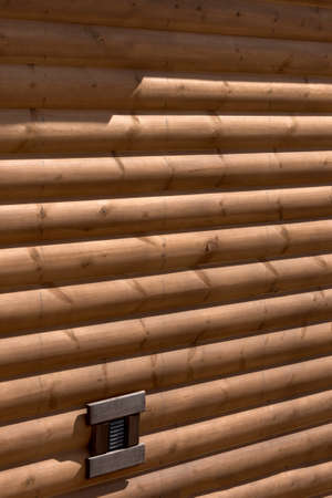 Wooden house from calibrated logs of brown colorの写真素材
