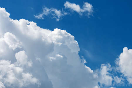 White fluffy big clouds against blue skyの写真素材