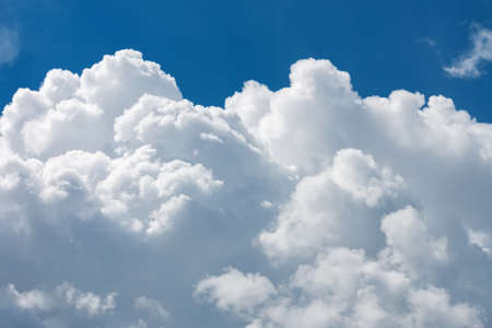 White fluffy big clouds against blue skyの写真素材