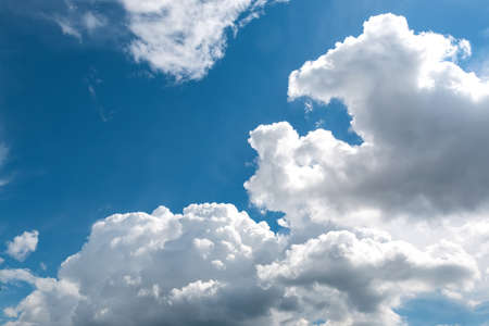 White fluffy big clouds against blue skyの写真素材