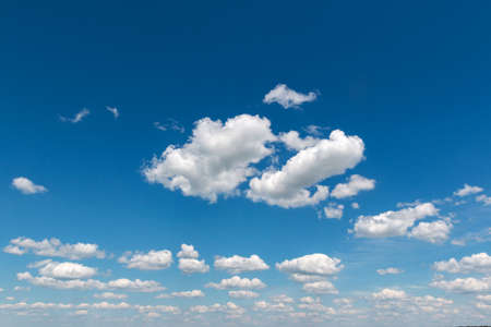White fluffy big clouds against blue skyの写真素材
