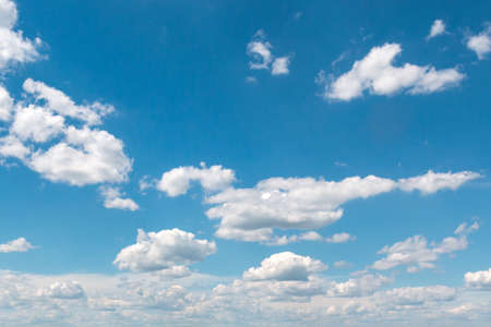 White fluffy big clouds against blue skyの写真素材