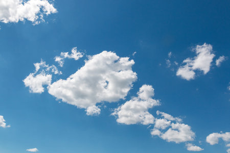 White fluffy big clouds against blue sky