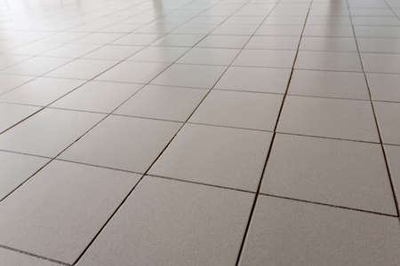 Office floor is lined with gray tilesの写真素材