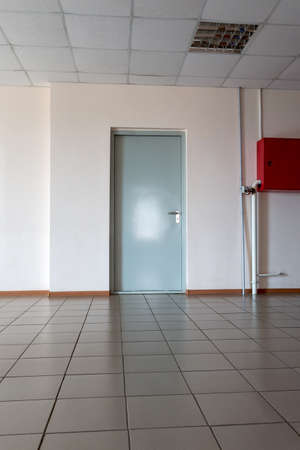 Door on the wall in an office room tiled floorの写真素材