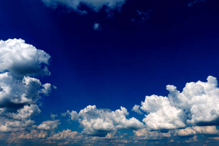 White fluffy cloud against a blue skyの写真素材