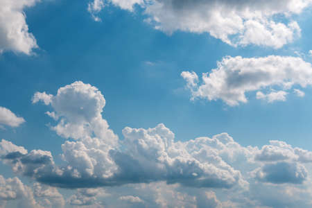 White fluffy cloud against a blue skyの写真素材