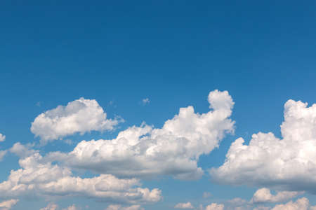 White fluffy cloud against a blue skyの写真素材