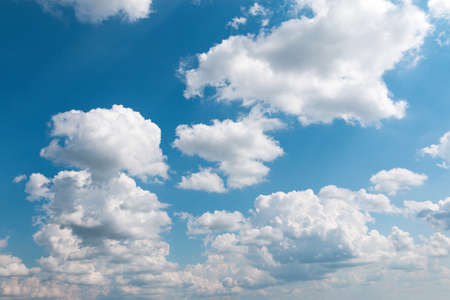 White fluffy cloud against a blue skyの写真素材