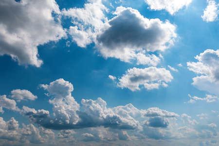 White fluffy big clouds against blue skyの写真素材
