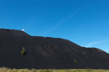 High black mountain and above it the blue skyの写真素材