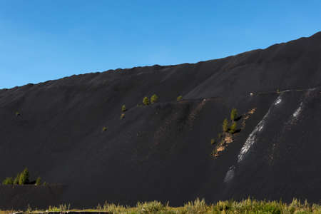 High black mountain and above it the blue skyの写真素材
