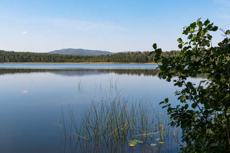 Picturesque view from the shore of a mountain lakeの写真素材