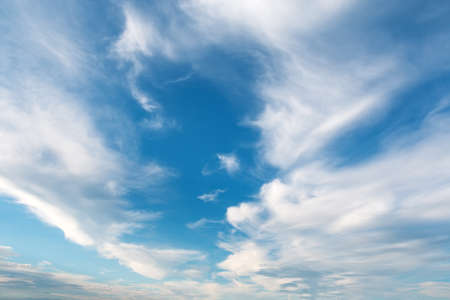 White fluffy cloud against a blue skyの写真素材