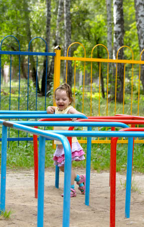 little girl is playing on the playgroundの写真素材