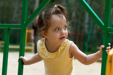 Little girl playing on the playgroundの写真素材