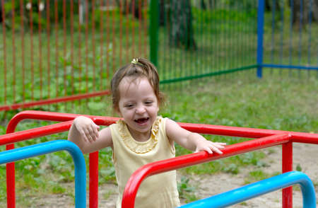 little girl is playing on the playgroundの写真素材