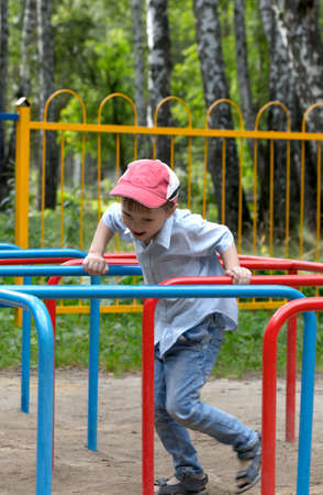 a little boy playing in the playgroundの写真素材