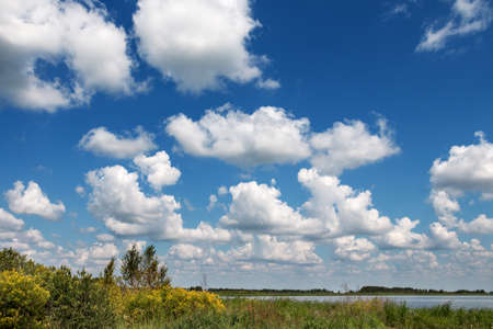 beautiful white clouds over the lakeの写真素材