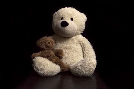 baby toy teddy bears on a black backgroundの写真素材