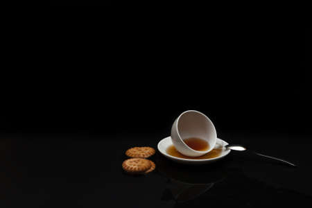 cup of tea inverted on a black backgroundの写真素材