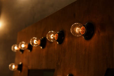 light bulbs on a dark wallの写真素材