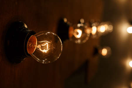 Garland of light bulbs on the wallの写真素材