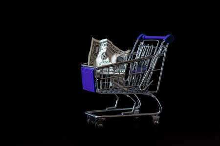 the dollar is in a cart from a supermarket for foodの写真素材