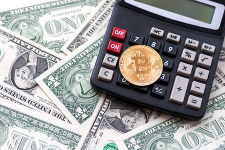 Crypto currency is on the calculator and dollarsの写真素材