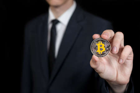 businessman holds a crypto currency in his handsの写真素材