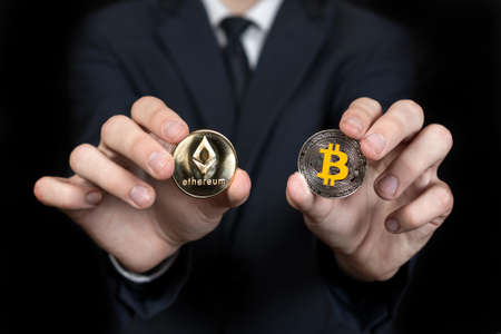 businessman holds a crypto currency in his handsの写真素材