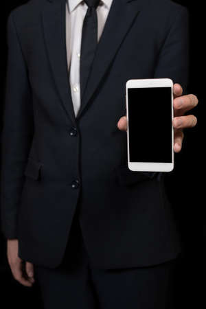 businessman holding a cell phone in handsの写真素材