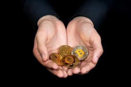 businessman holds a crypto currency in his handsの写真素材