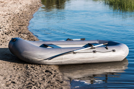 inflatable rubber fishing boat on the lake shore
