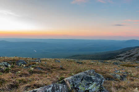 the rock rises against the blue sky in the rays of dawnの写真素材