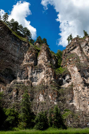 the rock rises against the blue sky in the rays of dawnの写真素材