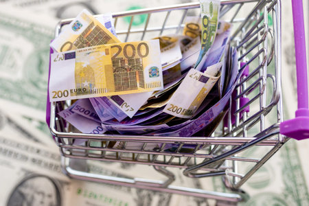 supermarket trolley full of euro notes costs dollarsの写真素材