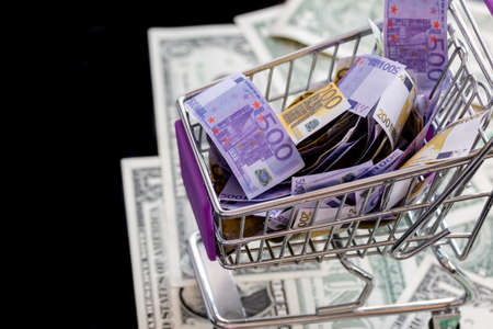 supermarket trolley full of euro notes costs dollarsの写真素材