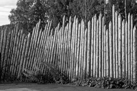 a very old rarity wooden fence made of logs is a good example of ancient architectureの写真素材