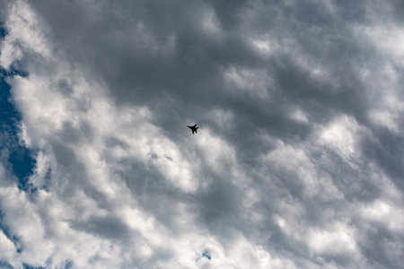 military aircraft flying in the background of clouds a