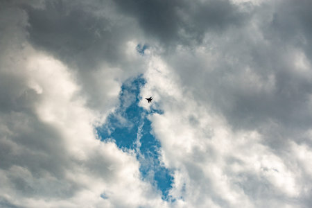 military aircraft flying in the background of clouds