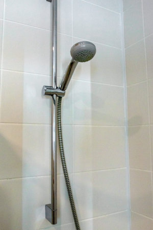 tile nozzle for shower water mounted on a tile wall