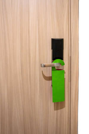 modern interior wooden door with a sign please clean in the roomの写真素材