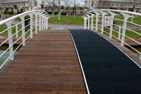 modern foot bridge over a creek in a parkの写真素材